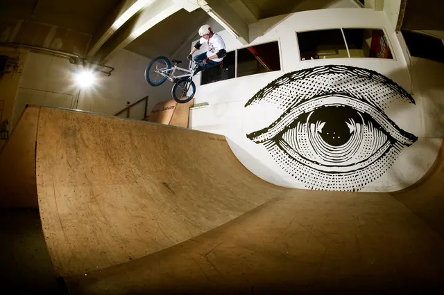 BMX rider on a ramp in front of a mural